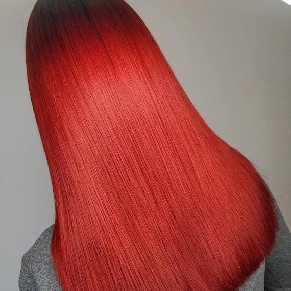Photo of the back of a woman’s head with long, straight, cherry red hair, created using Wella Professionals. 