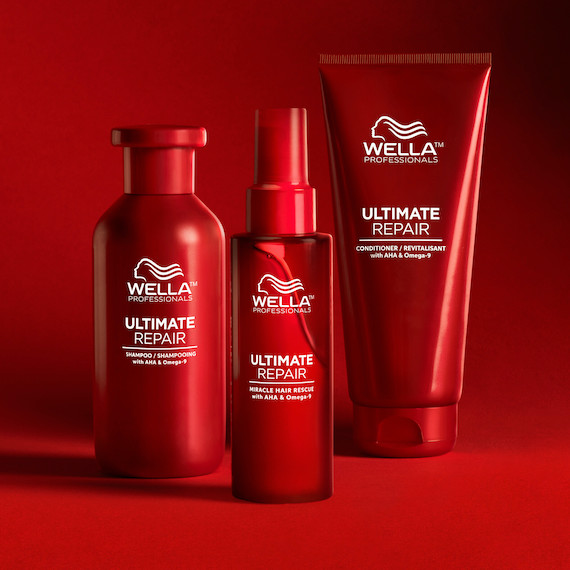 A line-up of the Ultimate Repair hair care collection pictured against a red backdrop to match the product packaging