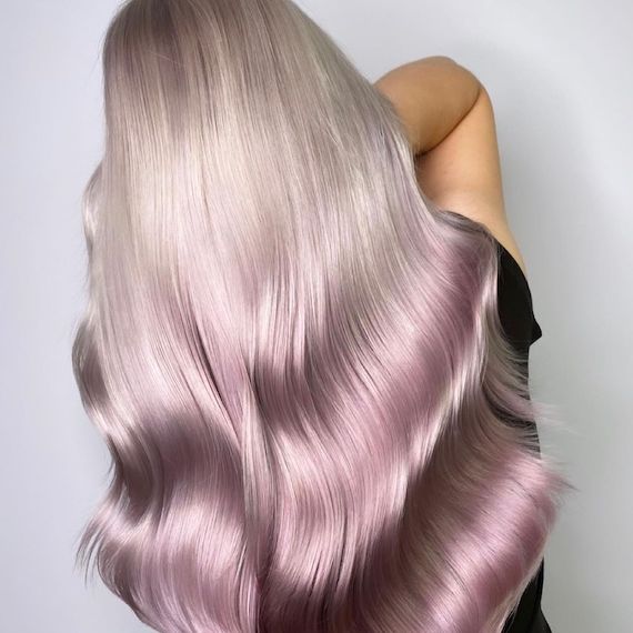 Back of person’s head reveals their ice blonde to platinum pink reverse ombre hair