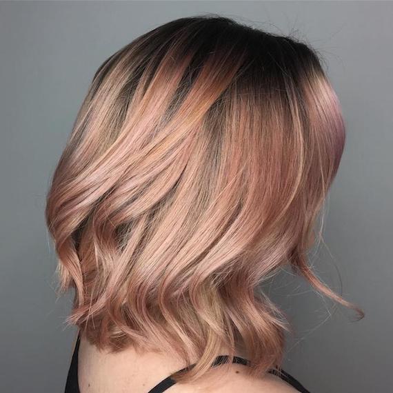 Side profile of woman with subtle rose gold hair, created using Wella Professionals. 