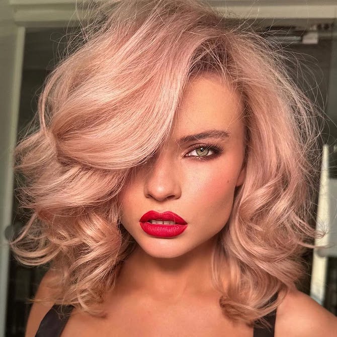 Model with light blonde, bouncy blow-dry with a subtle rose gold tint.