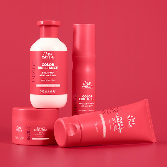 The complete collection of INVIGO Color Brilliance hair care products against a red backdrop.