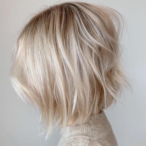 Side profile of woman with short baby blonde bob, created using Wella Professionals.