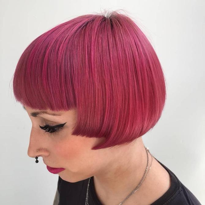 Side profile shot of woman with bright pink, very short bob hairstyle, created using Wella Professionals