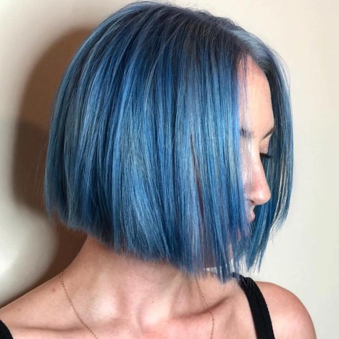 Side profile shot of woman with bright blue, short hairstyle, created using Wella Professionals