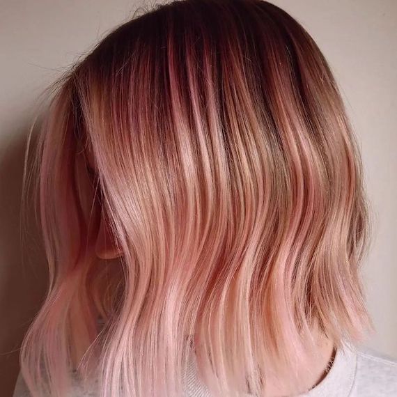 Model with short, pink and blonde ombre hair.