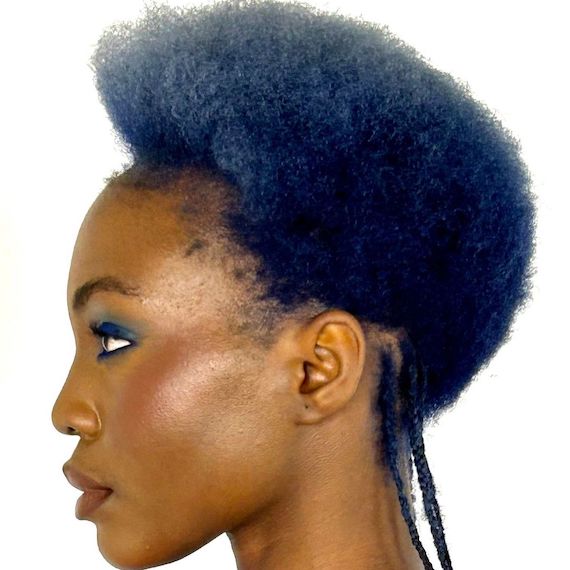 Model with short, coily, blue hair featuring a light to dark gradient effect.