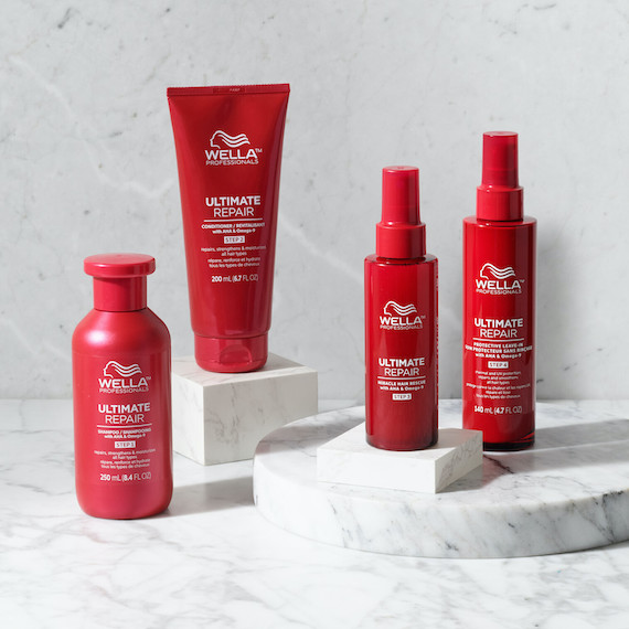 ULTIMATE REPAIR Shampoo, Conditioner, Miracle Hair Rescue and Protective Leave-In on a marble surface.