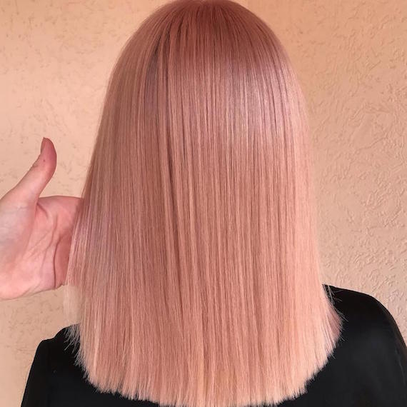 Back of woman’s head with super-straight, pink sombre hair, created using Wella Professionals.
