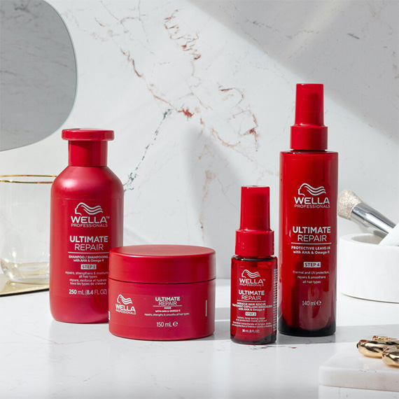 ULTIMATE REPAIR Shampoo, Mask, Miracle Hair Rescue and Protective Leave-In in a marble bathroom.