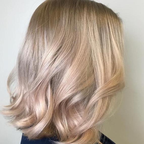 Side profile of model with short, cool blonde hair and subtle highlights, created using Wella Professionals. 