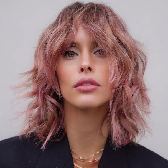 Model with shoulder-length shag haircut in a dusty pink shade.