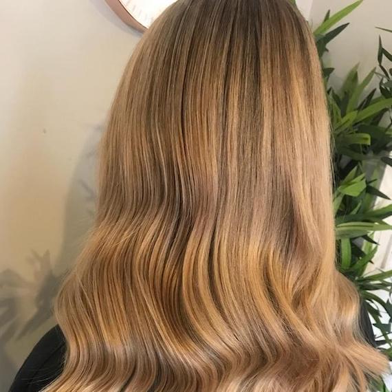 Back of a woman’s head showing dark blonde hair, created using Wella Professionals