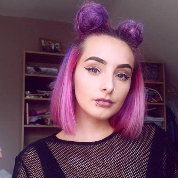 Woman with pink and purple hair tied up in space buns, styled using Wella Professionals