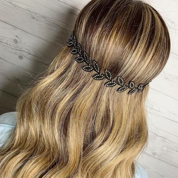 Back of a woman’s head showing a boho headband placed over wavy hairstyle