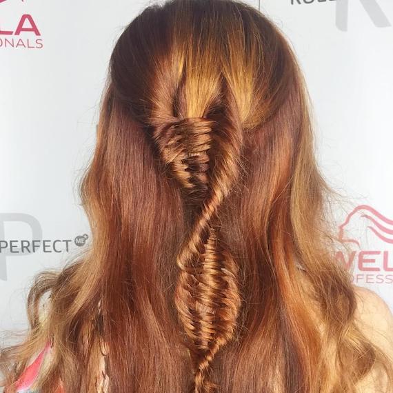 Back of a woman’s head showing hair twisted into a DNA braid, styled using Wella Professionals