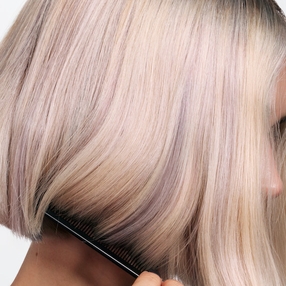 Close-up of model’s platinum blonde highlights.