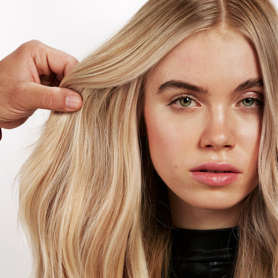 Closer look at the blended highlights through a model’s golden blonde hair.