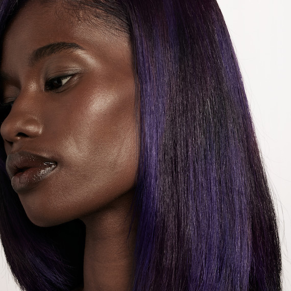 Close-up of model’s dark brown hair and violet highlights.