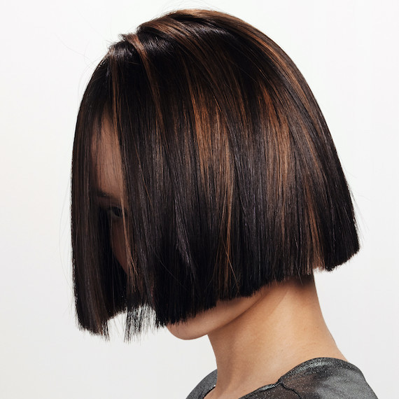 Close-up model’s chocolate brown and caramel hair colour.
