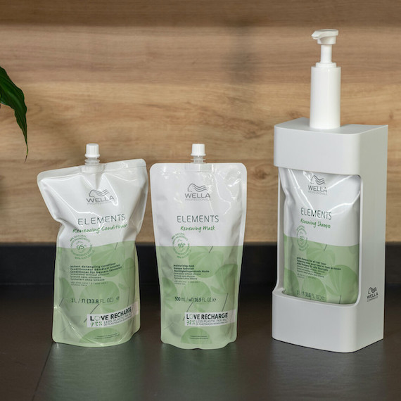 Wella Elements hair care pouches next to the Elements recharge station.
