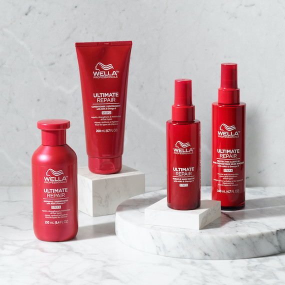ULTIMATE REPAIR Shampoo, Conditioner, Miracle Hair Rescue and Protective Leave-In on a marble surface.