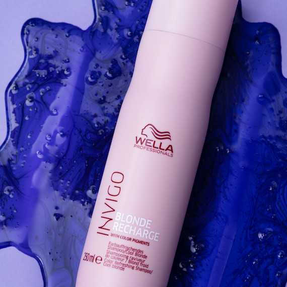 INVIGO Blonde Recharge Cool Blonde Shampoo bottle surrounded by purple shampoo.
