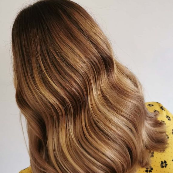 Back of woman’s head with blonde hair and subtle blonde highlights.