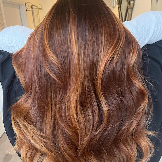 Close-up of walnut bronde hair that's been coloured with copper highlights