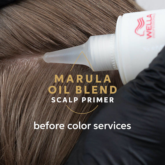 Marula Oil Blend Scalp Primer is applied to model’s scalp.