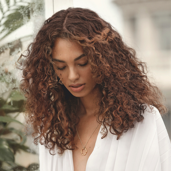 Model with curly hair, styled using Wella Professionals products