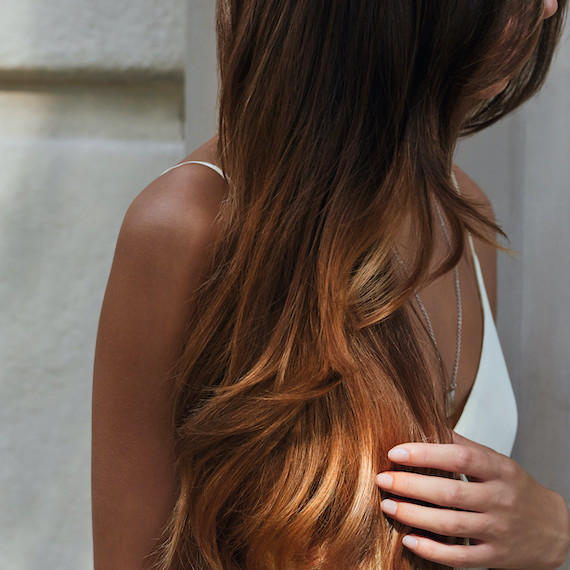 Close-up of the lengths of a person's light brown hair 
