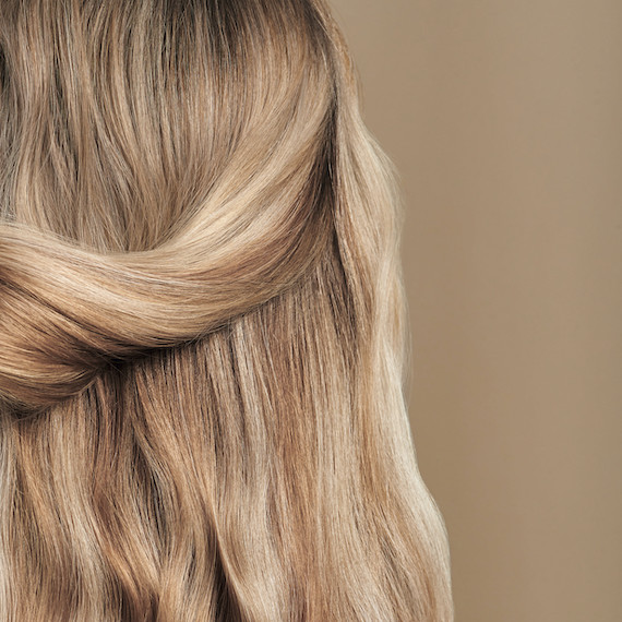 Close-up of model’s wavy, honey blonde hair.