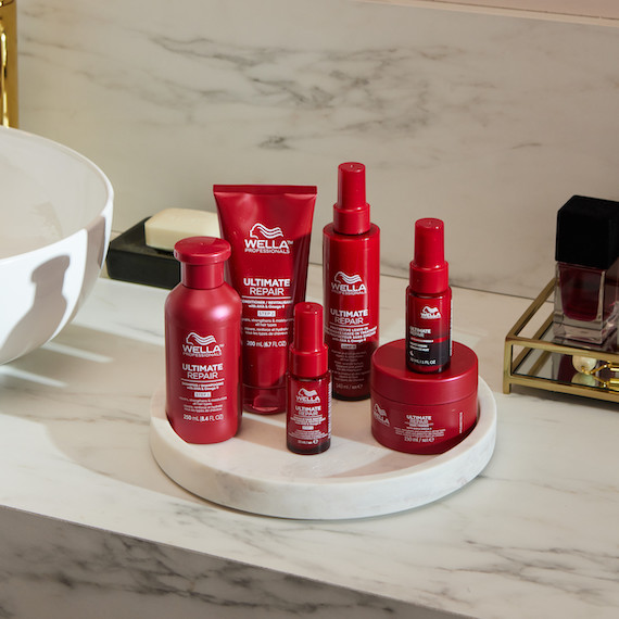 ULTIMATE REPAIR Shampoo, Conditioner, Miracle Hair Rescue, Protective Leave-In, Night Serum and Mask in a marble bathroom.