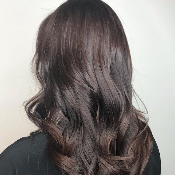 Photo of woman’s hair with bitter chocolate brown hair color. Look created by Wella Professionals.