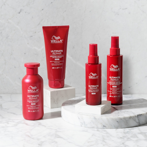 ULTIMATE REPAIR Shampoo, Conditioner, Miracle Hair Rescue and Protective Leave-In on a marble surface.