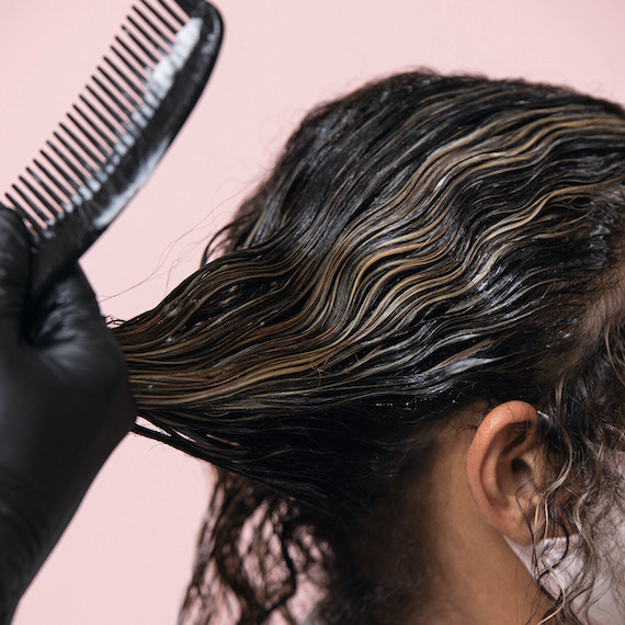 Close up of hairdresser working on client's hair 