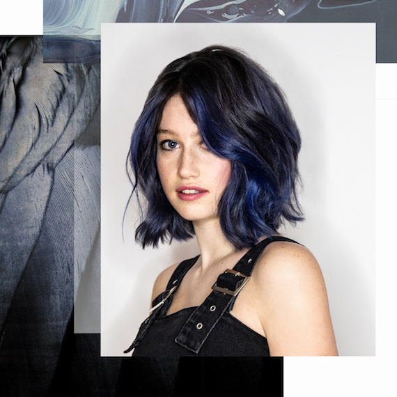 Model with wavy, blue-black hair, created using Wella Professionals