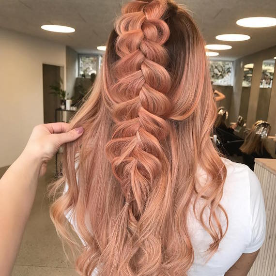 Back of woman’s head showing twist half-up hairstyle, created using Wella Professionals