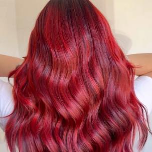 Back of model’s head with long, wavy, cherry red hair.