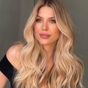 Model with long, honey blonde hair featuring extra lightness through lengths and ends.