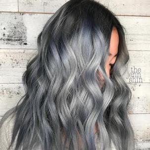 Side profile of model with long, ash blue hair styled in tousled waves.