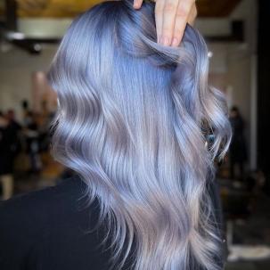 Back of model’s head with long, loosely tousled, blue ombre hair.