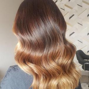 Back of woman’s head with long, wavy, bronde ombre hair, created using Wella Professionals.