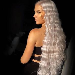 Back of model’s head with super long, ice blonde hair styled in mermaid waves.