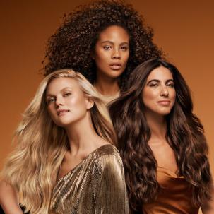 Three models: one with blonde, wavy hair, one with brown, curly hair, and one with long, tousled brown hair.