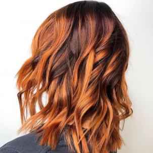 Woman with pumpkin spice wavy hair