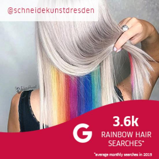 Model with platinum hair lifting her hair to reveal highlights with the rainbow colors, created using Wella Professionals