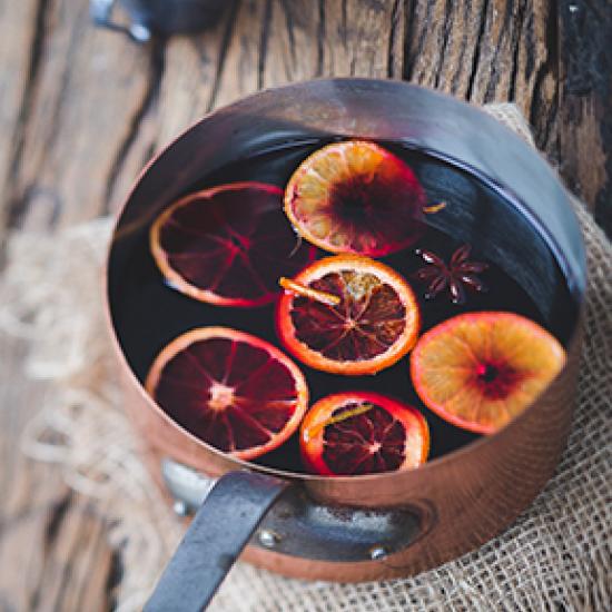 Mulled wine with orange slices in