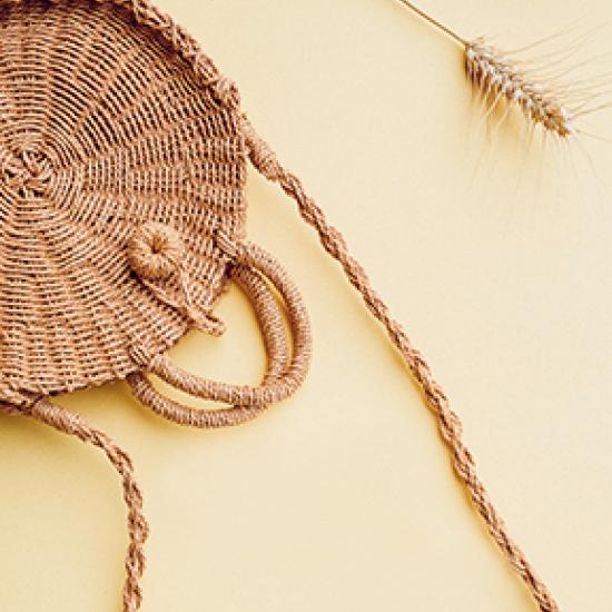 Wicker bag on a cream colored background